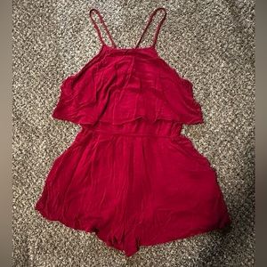 Maroon flowy romper with pockets and adjustable straps.